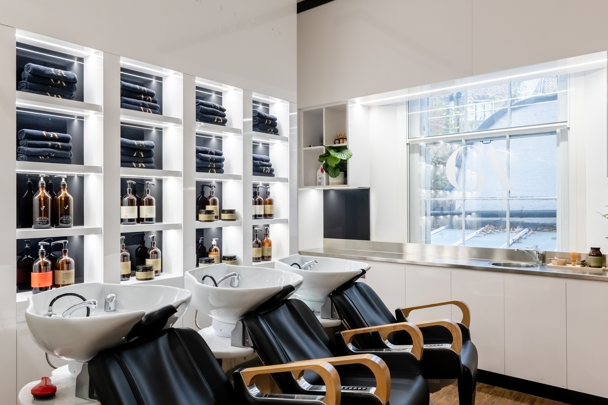 Hair washing area with luxury black towels and premium products