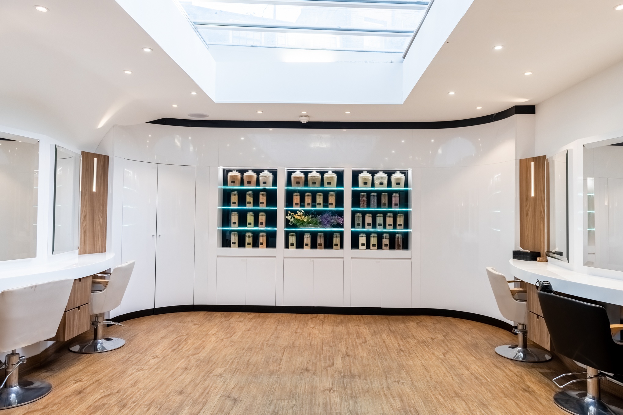 Bright modern salon floor with skylight and multiple styling stations