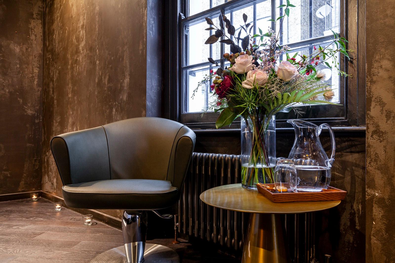 Elegant waiting area with fresh floral arrangements at GA Salons Chelsea